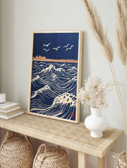 Stylised navy blue ocean waves with white crests and flying seagulls, distant land, in, in an alternate framed mockup