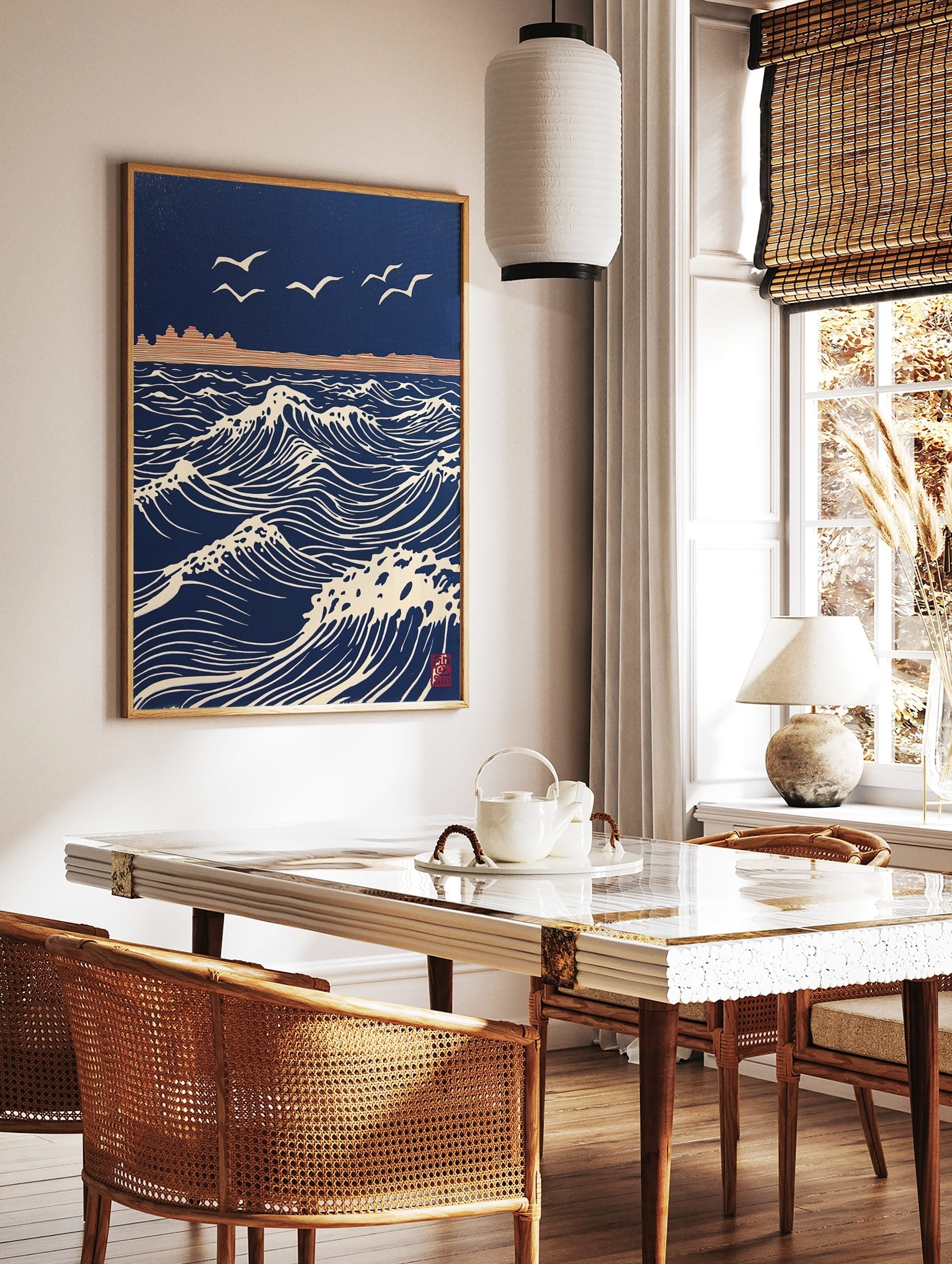 Stylised navy blue ocean waves with white crests and flying seagulls, distant land, in woodblock, in a styled room mockup
