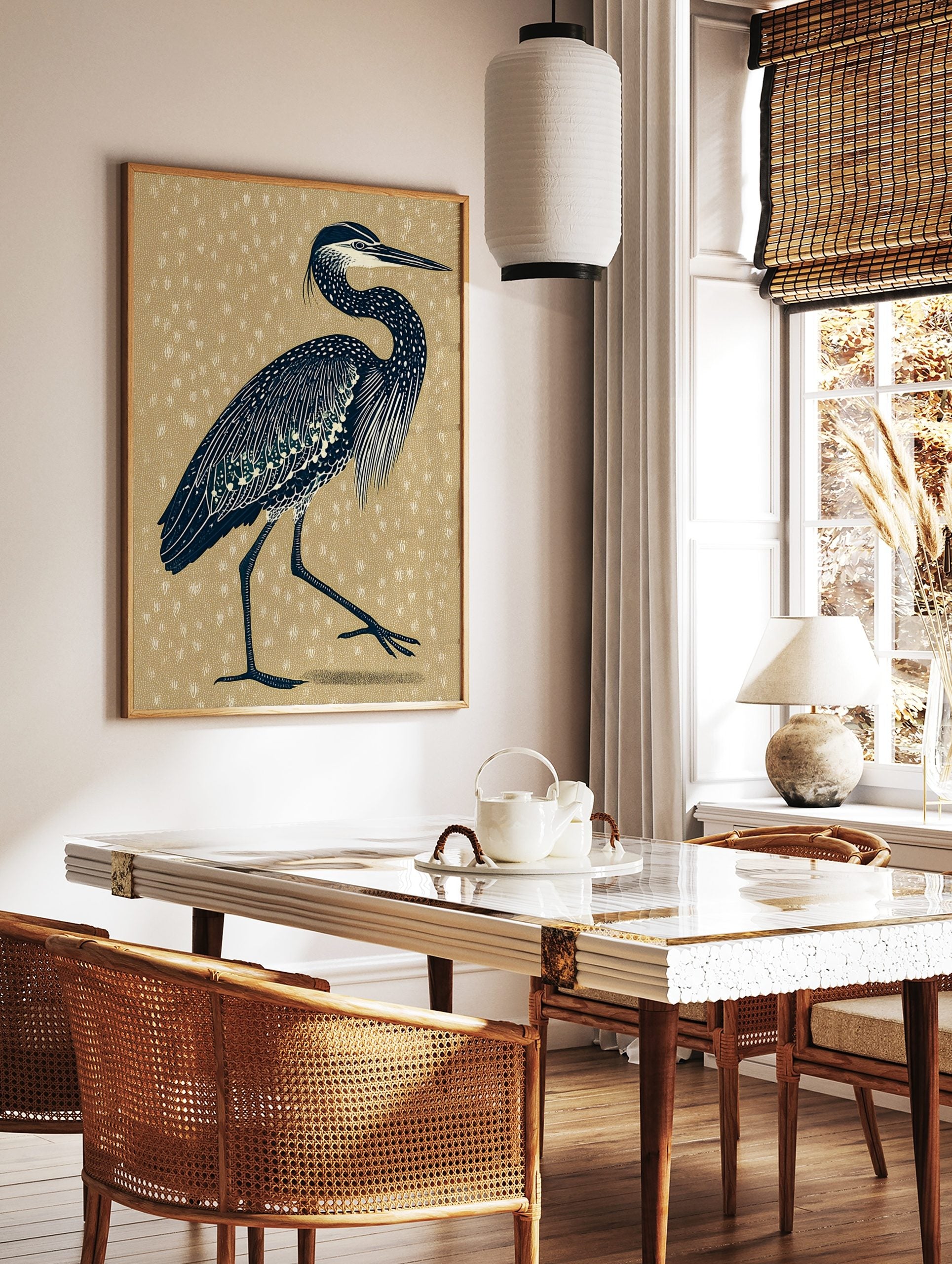 Illustrative navy heron bird print with white details on a textured beige background, portrait, in a styled room mockup