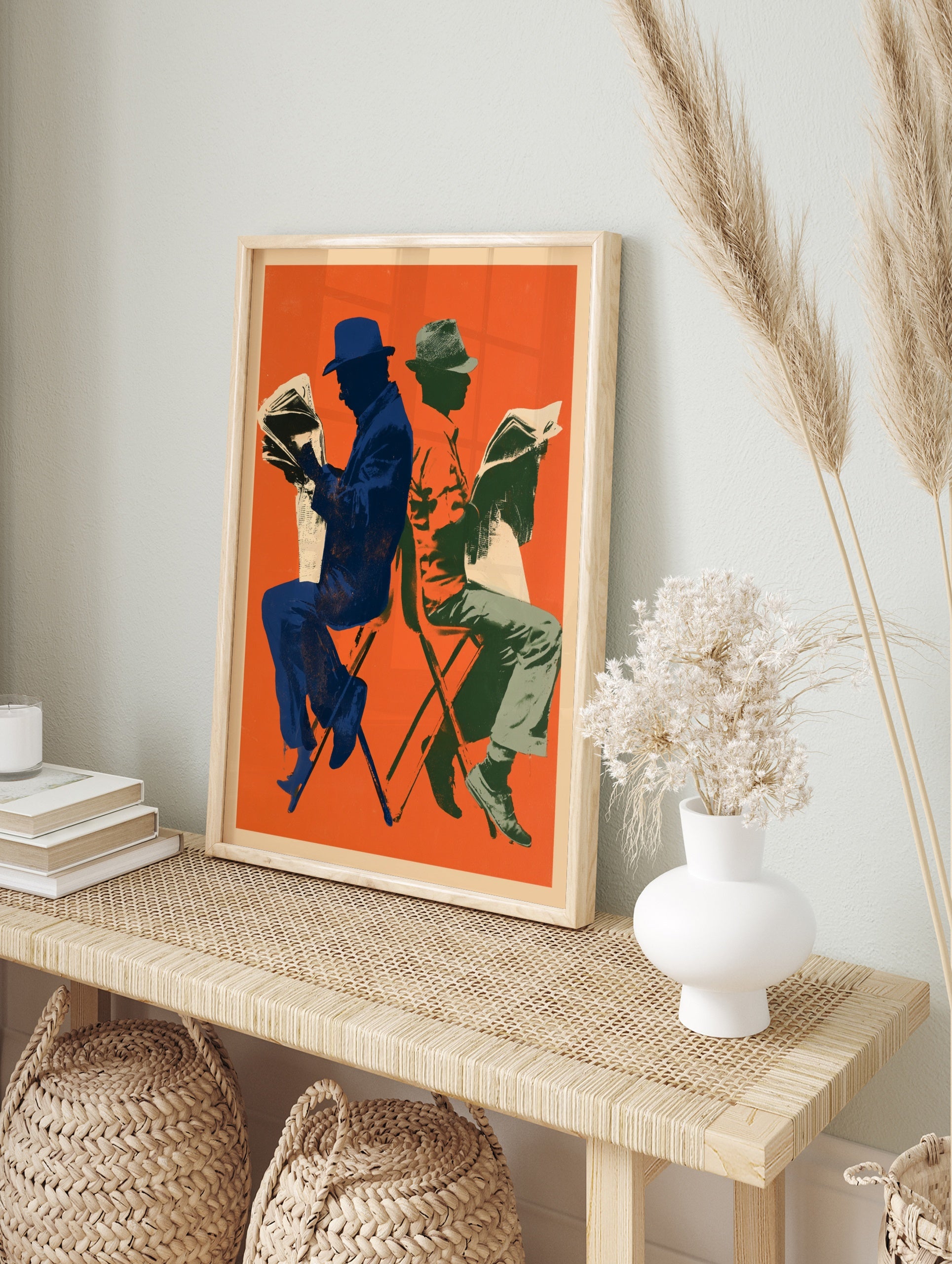 Retro illustrative art print of two figures reading newspapers against a vibrant orange, in an alternate framed mockup