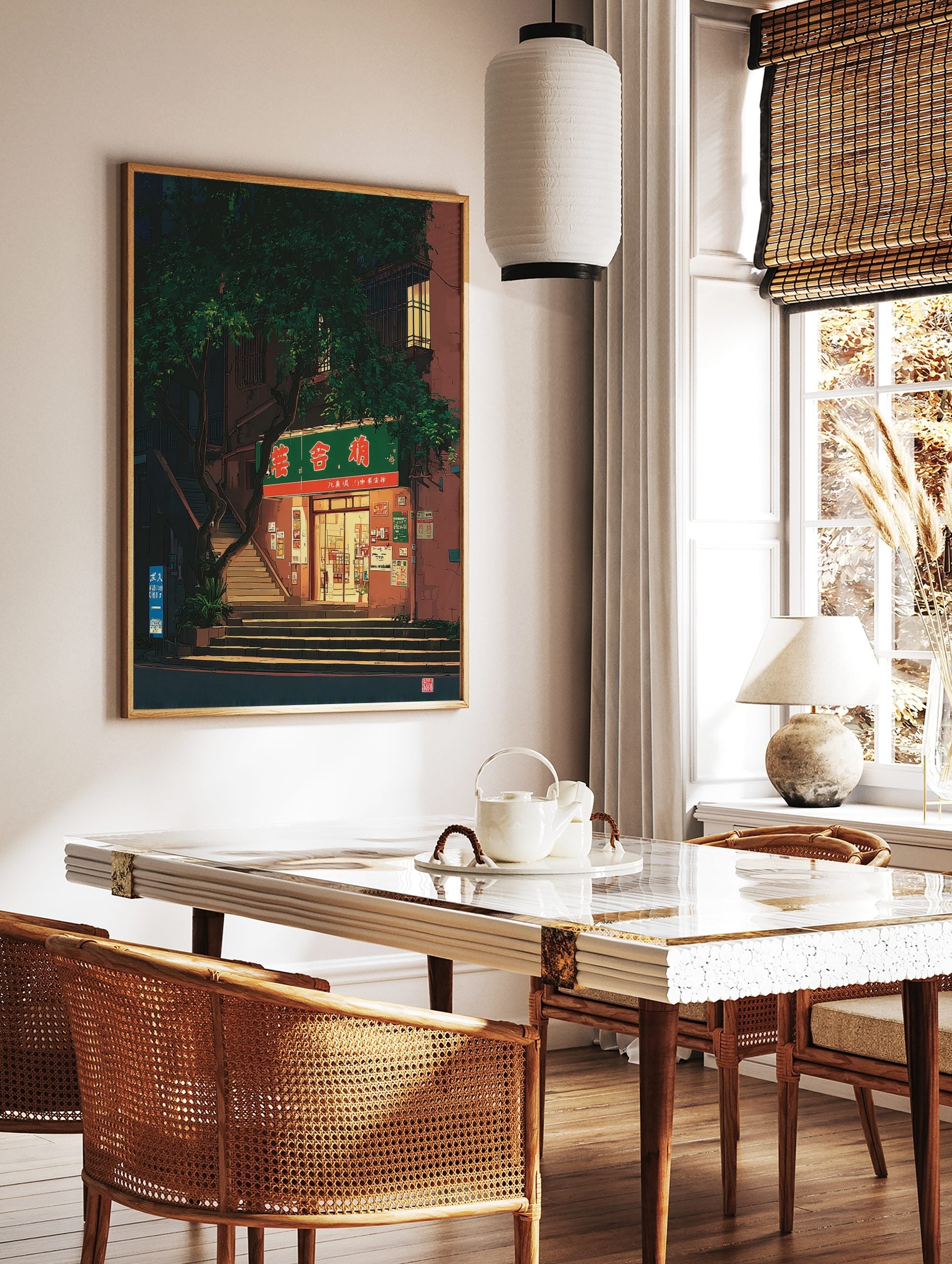 Illustrative print of a shop entrance at night, with a green sign, steps, and a large tree, in a styled room mockup