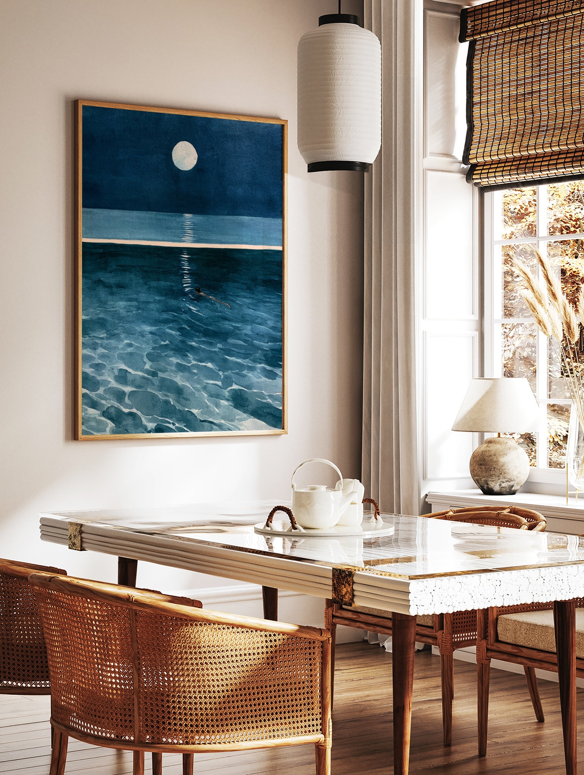 Illustrative wall art of a solitary figure swimming in deep blue ocean water under a full moon with, in a styled room mockup
