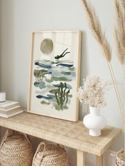 Abstract ocean diver swimming over blue-green water with a large beige sun and underwater, in an alternate framed mockup