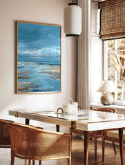 Textured blue ocean seascape painting with white waves crashing on a wet sandy beach under a cloudy, in a styled room mockup