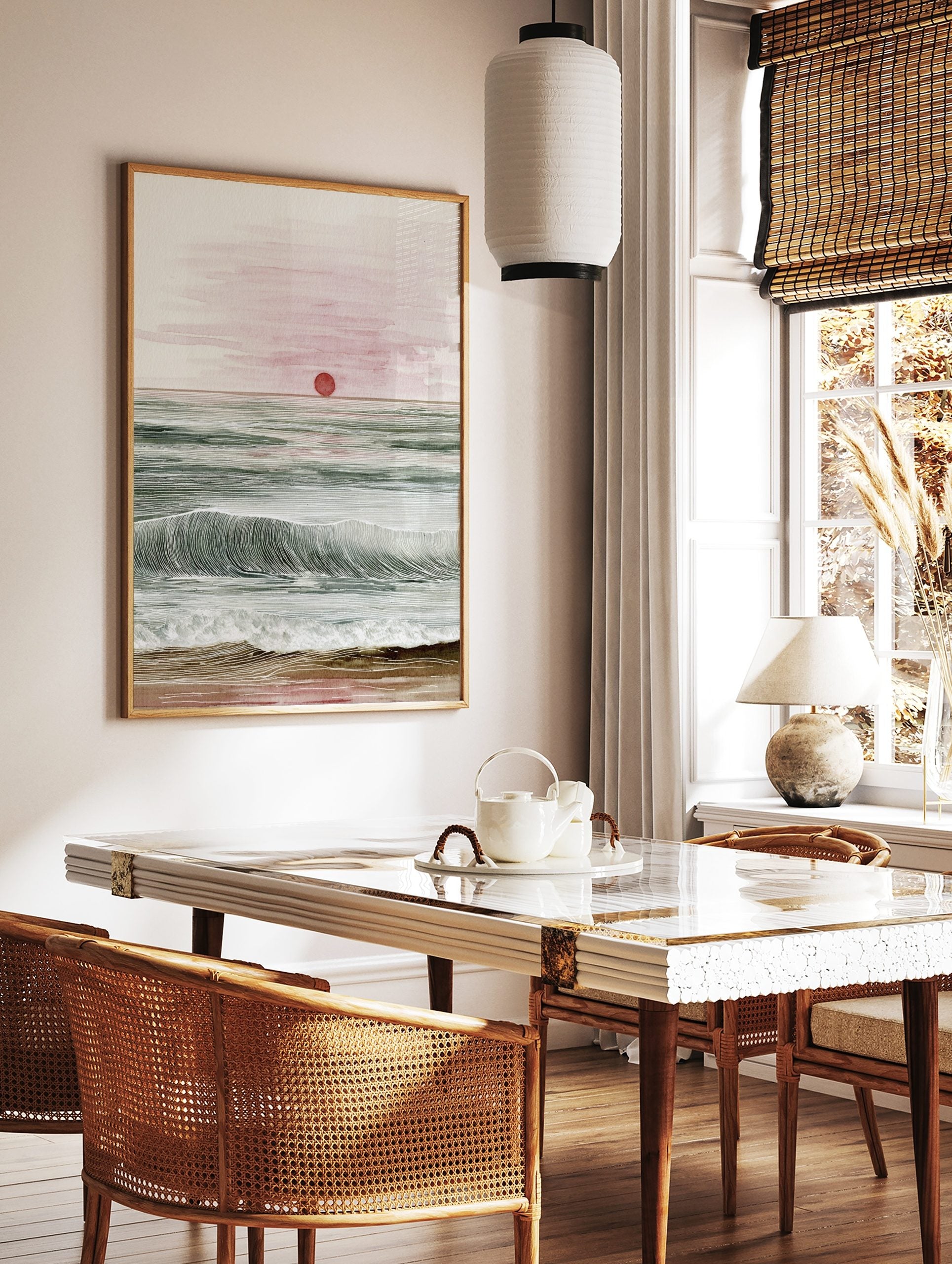 Ocean sunset watercolour and line art print with red sun, green waves, and sandy beach, in a styled room mockup