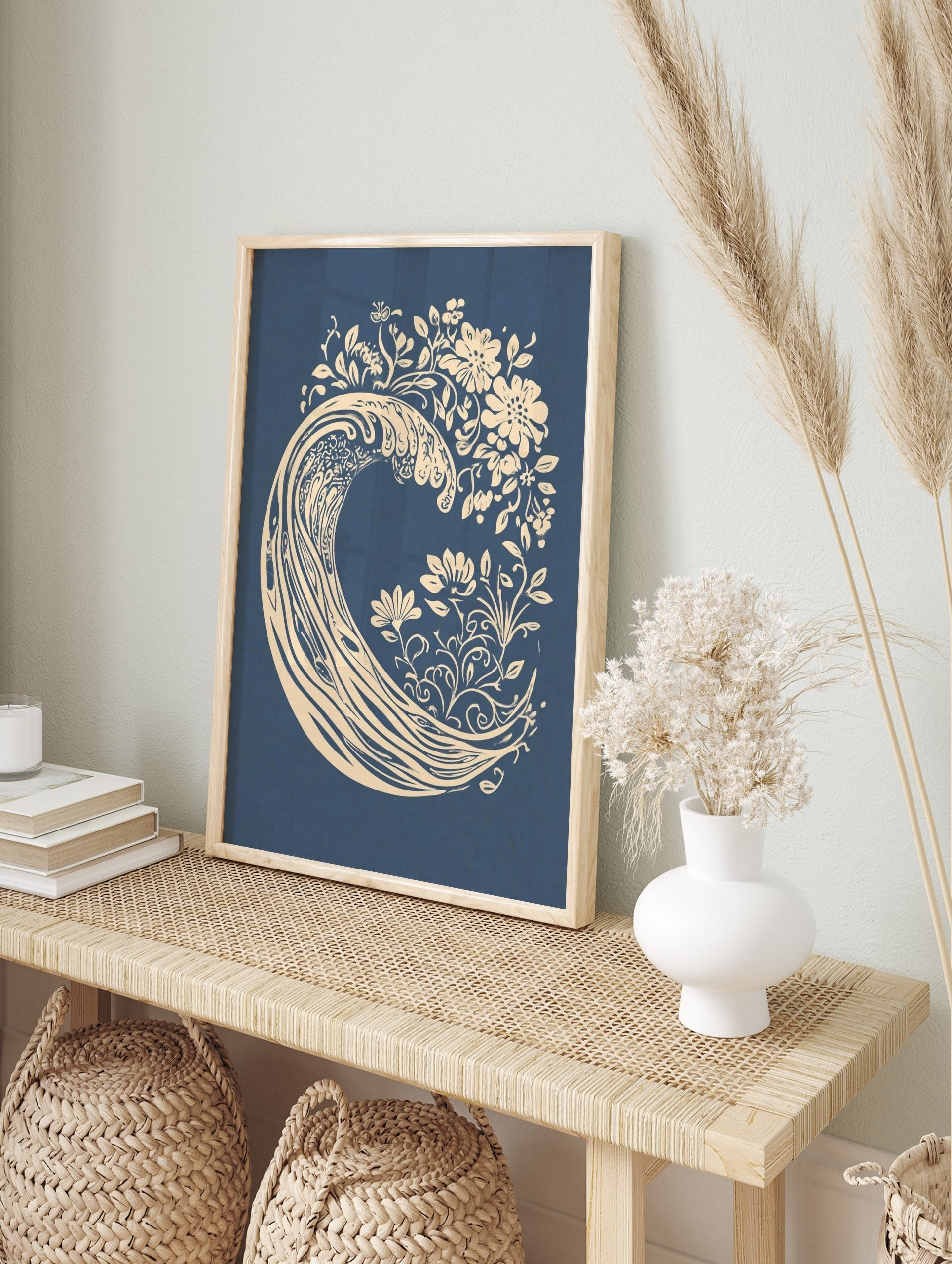 Stylised cream ocean wave with botanical flowers and leaves on a deep blue background, in an alternate framed mockup