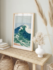 Illustrative ocean wave art print with blue and green water, white foam, and light blue sky, in an alternate framed mockup