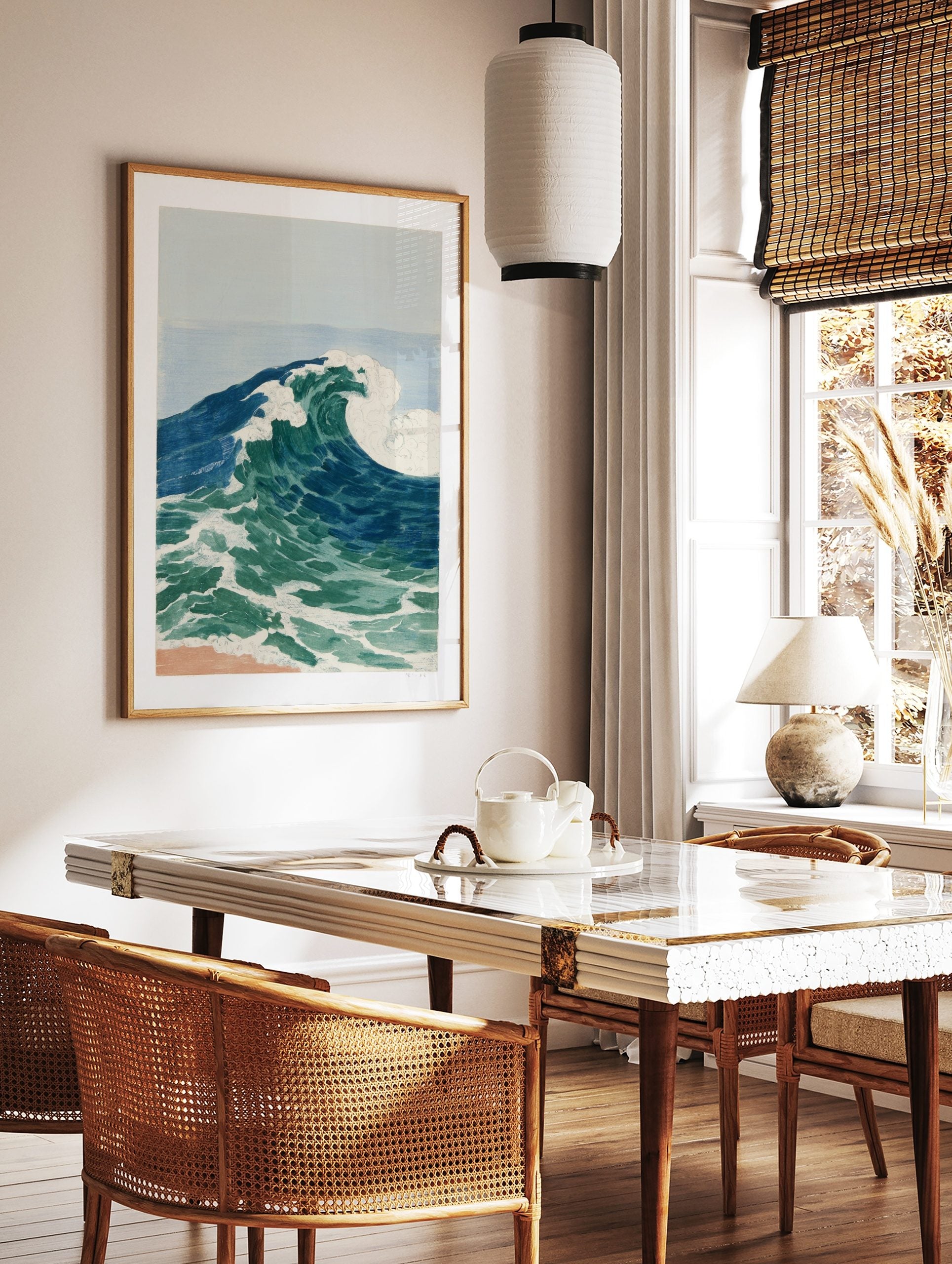 Illustrative ocean wave art print with blue and green water, white foam, and light blue sky over a, in a styled room mockup