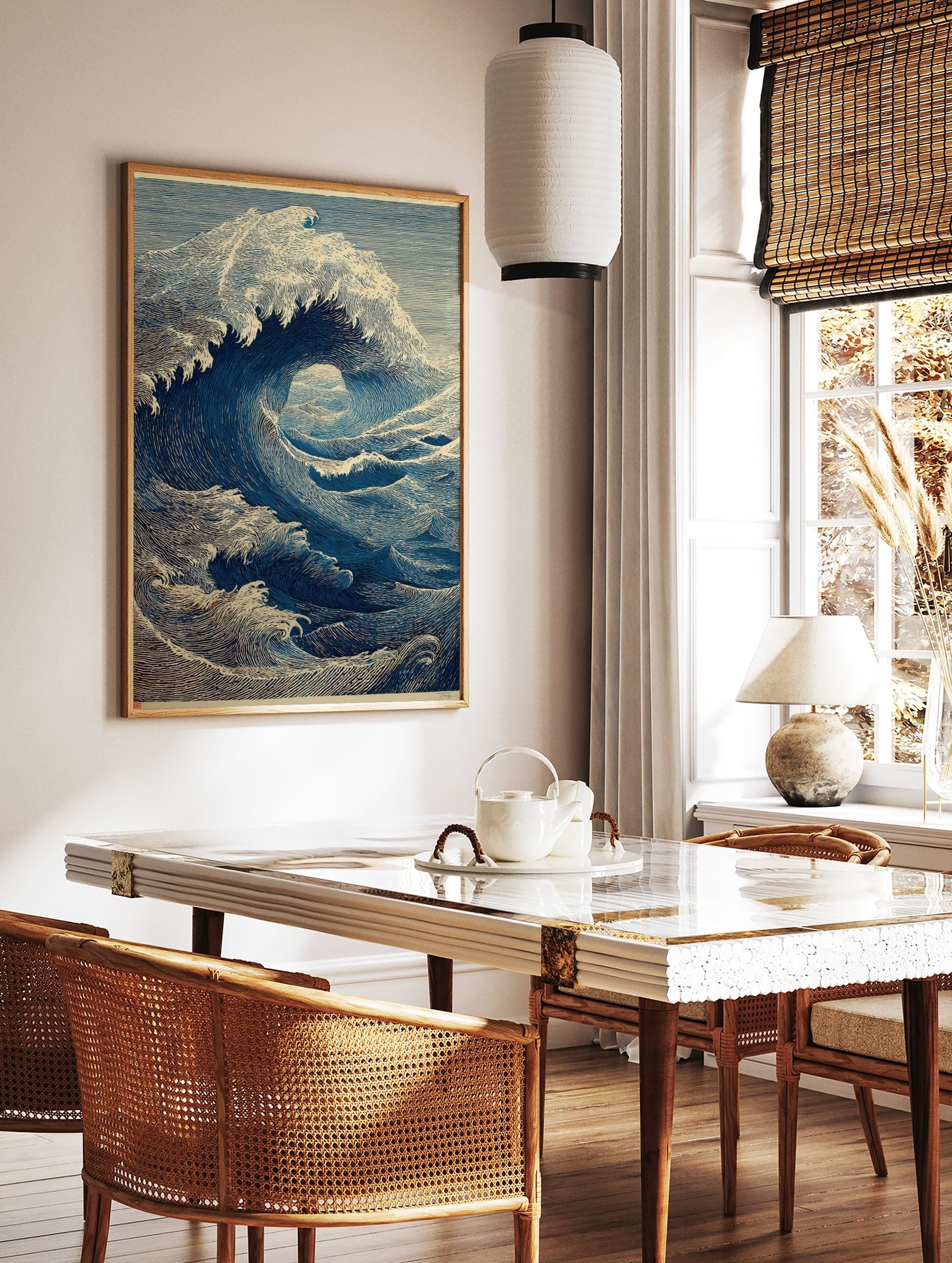 Illustrative blue ocean wave art print in woodcut style, showing a large breaking wave with foam, in a styled room mockup