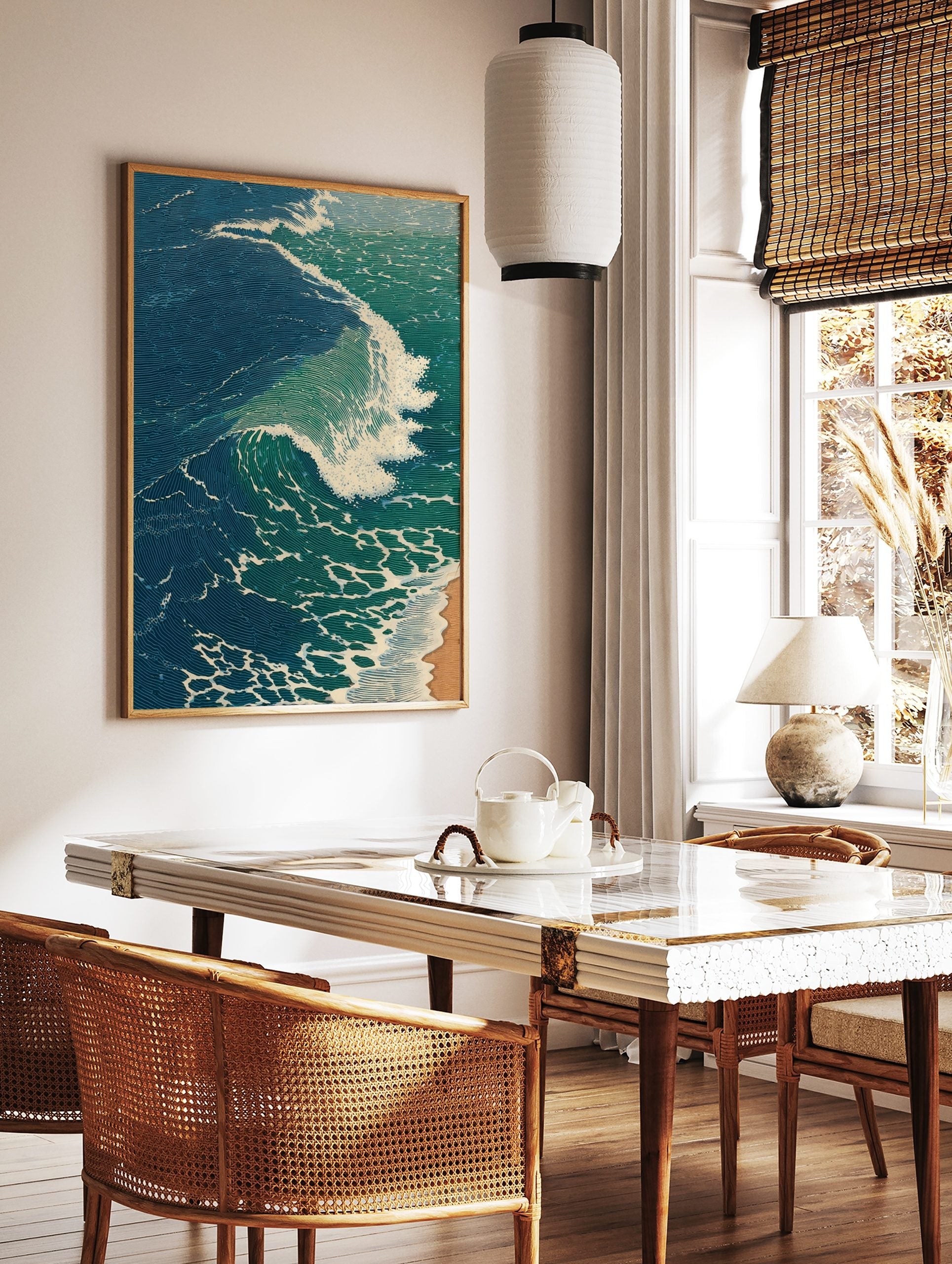Illustrative print of a large ocean wave with blue-green water and white foam breaking onto a sandy, in a styled room mockup