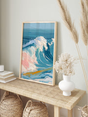 Textured painting of a large blue ocean wave with white foam and pink highlights, golden, in an alternate framed mockup