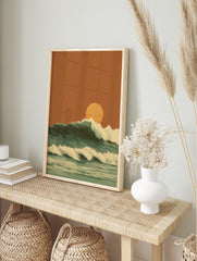 Illustrative ocean waves with white foam crests and a large orange setting sun against an, in an alternate framed mockup