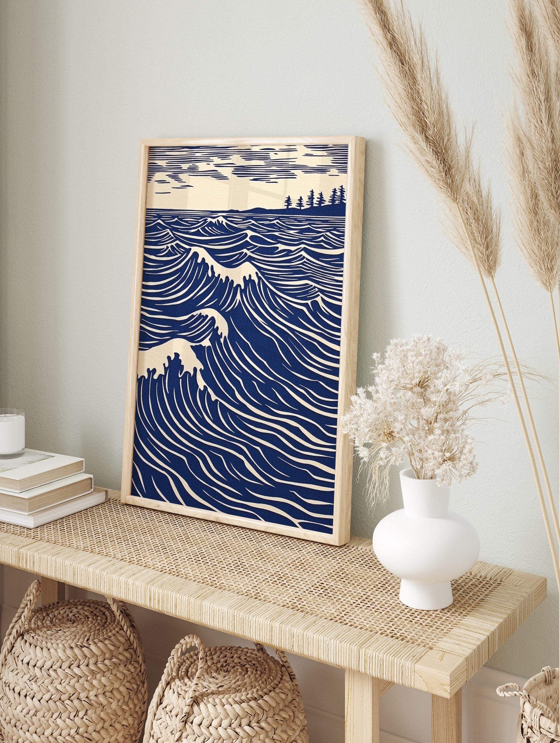 Illustrative blue ocean waves with white crests, a distant tree-lined coast, and striped sky, in an alternate framed mockup
