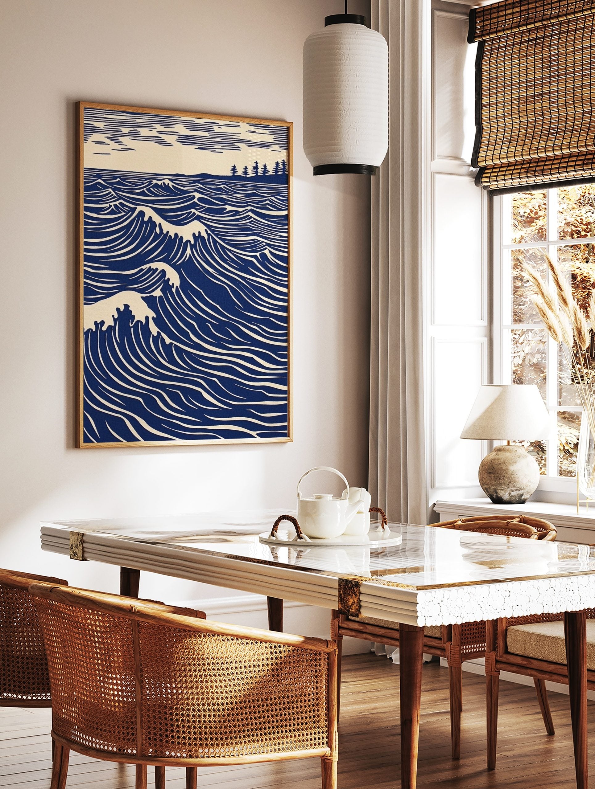 Illustrative blue ocean waves with white crests, a distant tree-lined coast, and striped sky art, in a styled room mockup