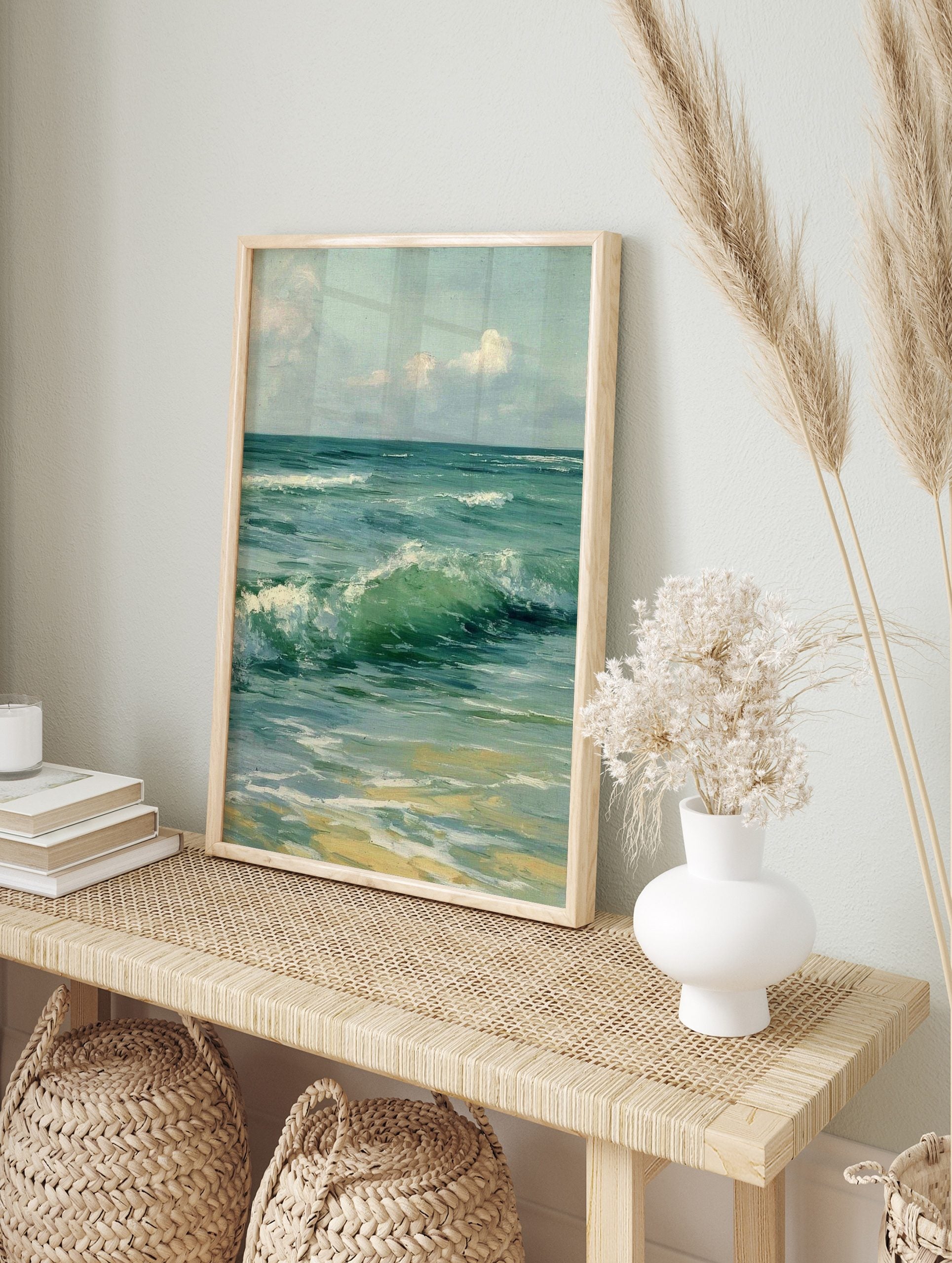 Close-up painting of green and blue ocean waves crashing onto a sandy beach under a cloudy sky, in an alternate framed mockup