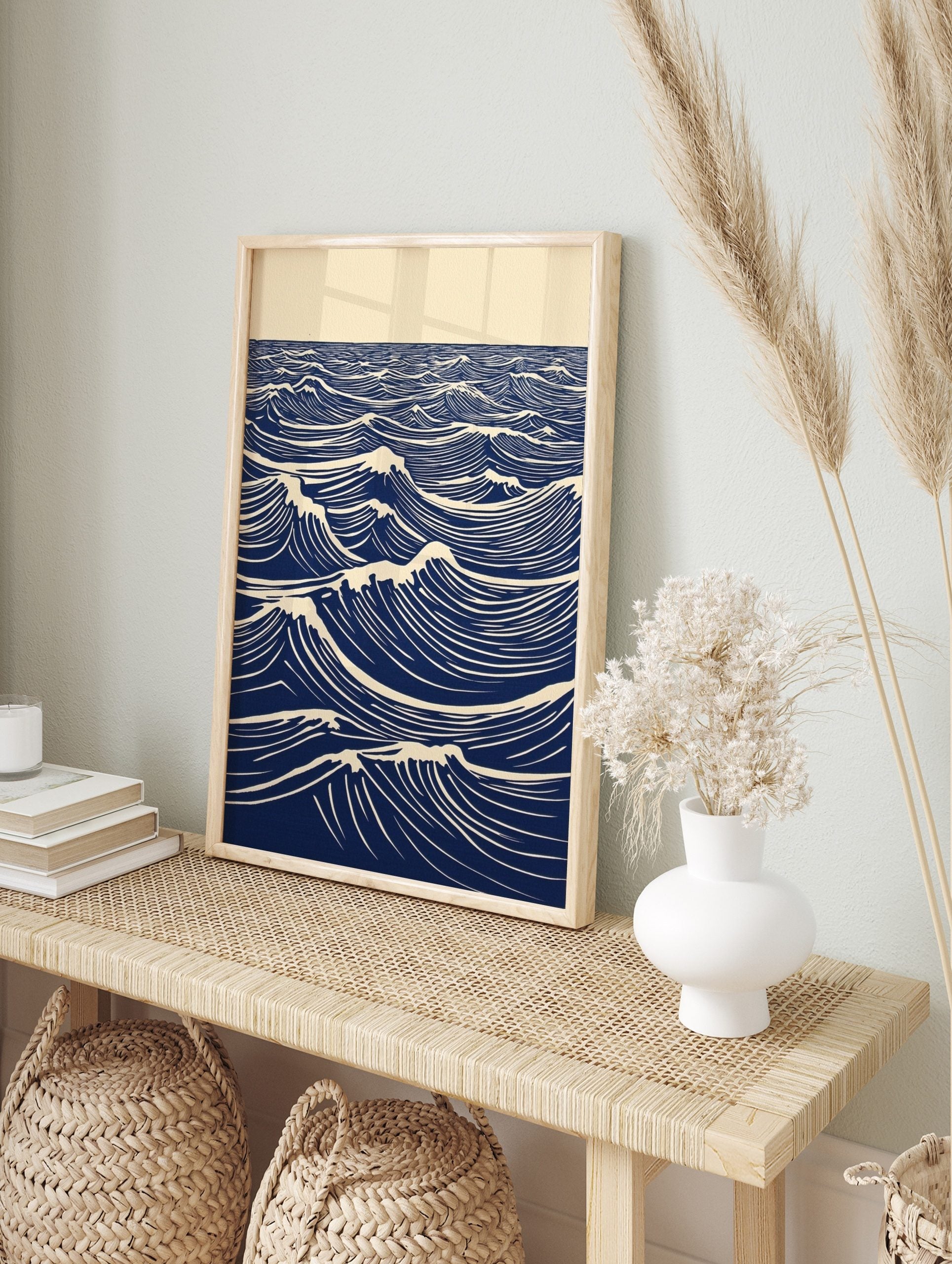 Stylised blue and white lino print of ocean waves with foam crests extending to the horizon, in an alternate framed mockup