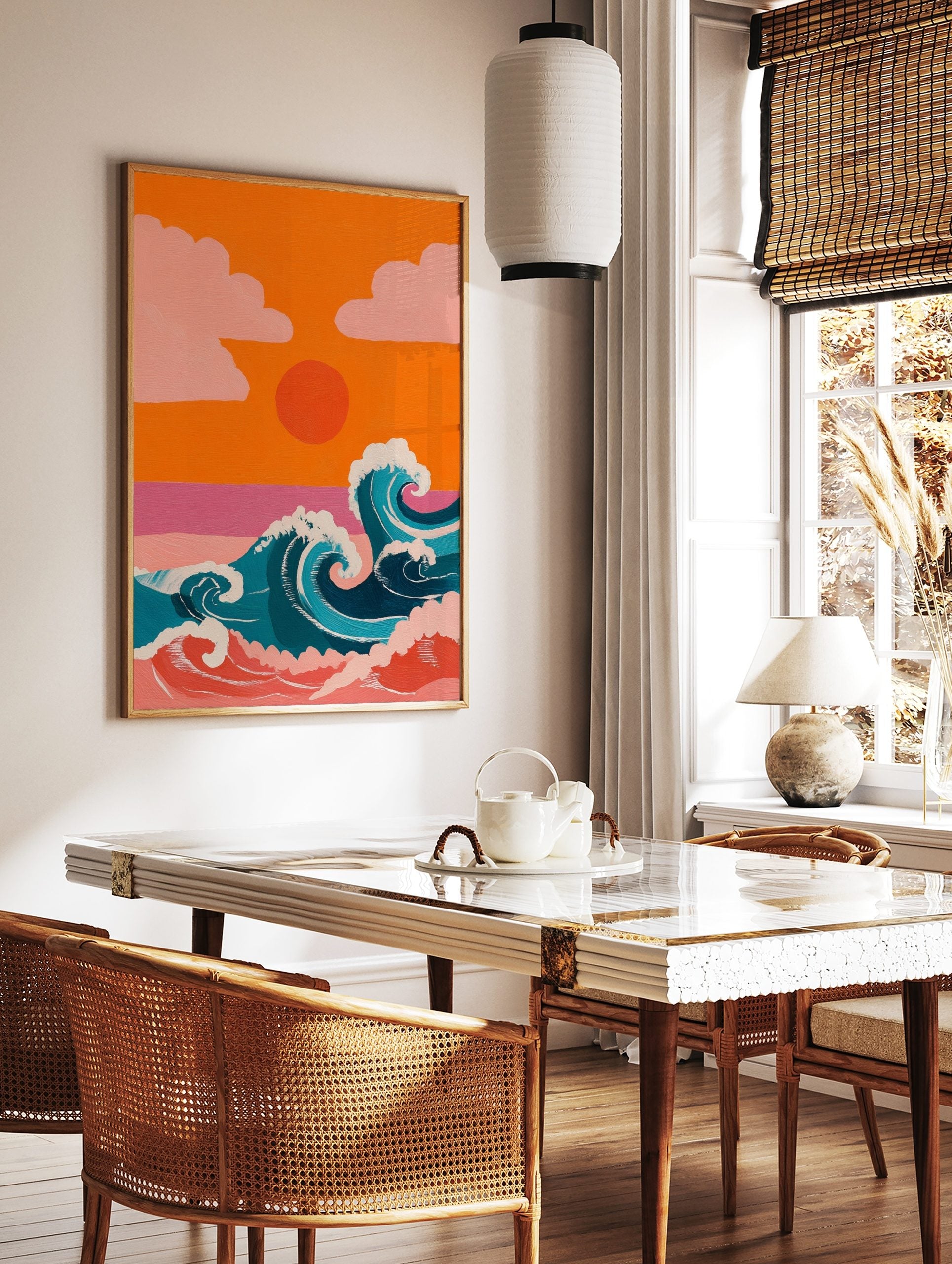 Illustrative ocean waves with white foam, orange sunset, and pink clouds against an orange sky, in a styled room mockup