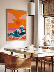 Illustrative ocean waves with white foam, orange sunset, and pink clouds against an orange sky, in a styled room mockup