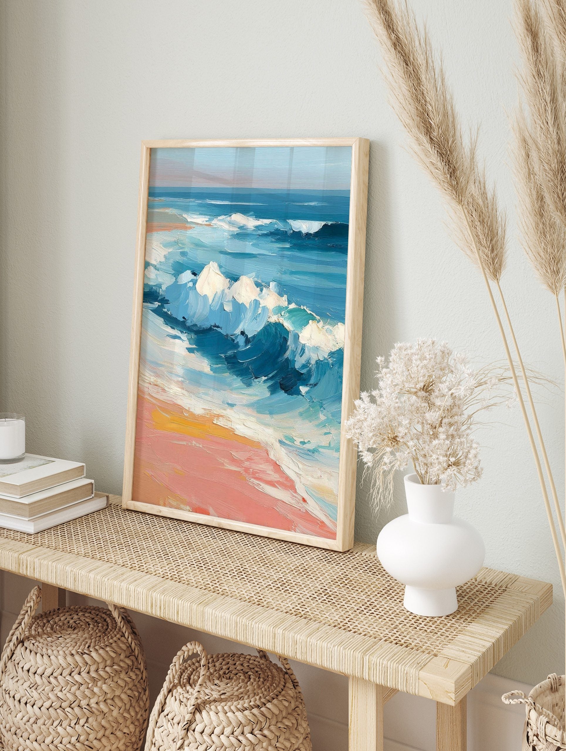 Impressionist painting of blue ocean waves crashing onto a peach and yellow sandy beach with, in an alternate framed mockup