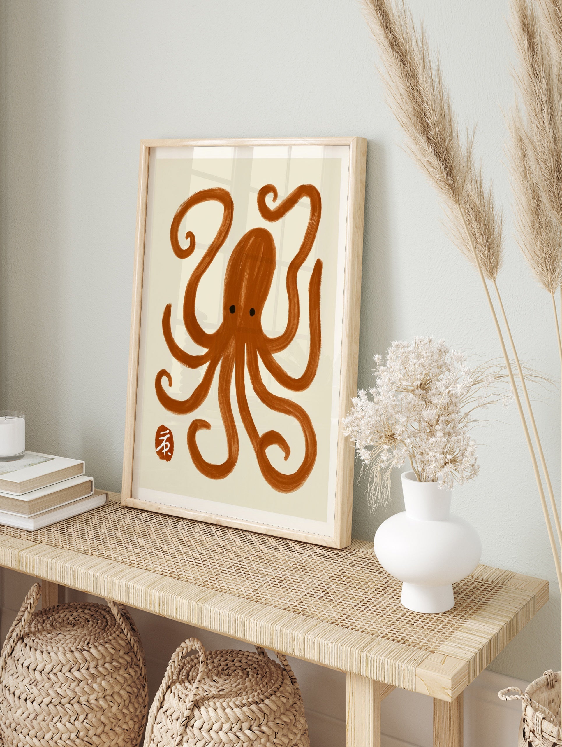 Minimalist brown octopus illustration with brush-stroke texture and a small red seal mark on, in an alternate framed mockup