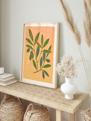 Botanical illustration of an olive branch with green leaves and blue olives on a textured, in an alternate framed mockup