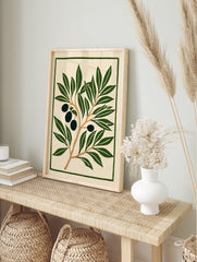 Olive branch botanical illustration with dark olives and green leaves on cream background, in an alternate framed mockup