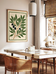 Olive branch botanical illustration with dark olives and green leaves on cream background, in a styled room mockup