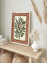 Botanical olive branch illustration with red berries and a decorative geometric border on a, in an alternate framed mockup