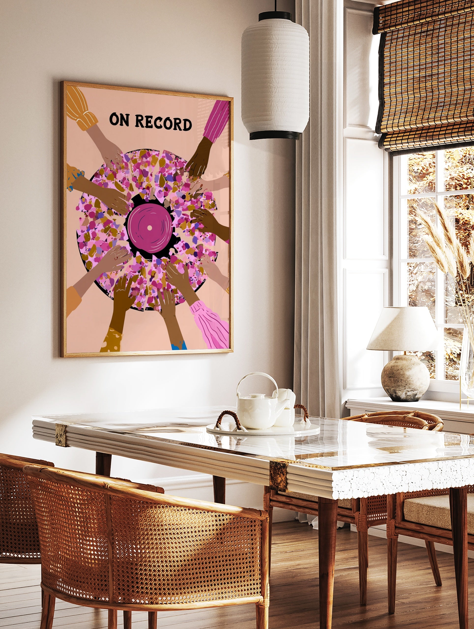 Illustrative wall art of a vinyl record surrounded by hands with ON RECORD text in pink, purple, in a styled room mockup