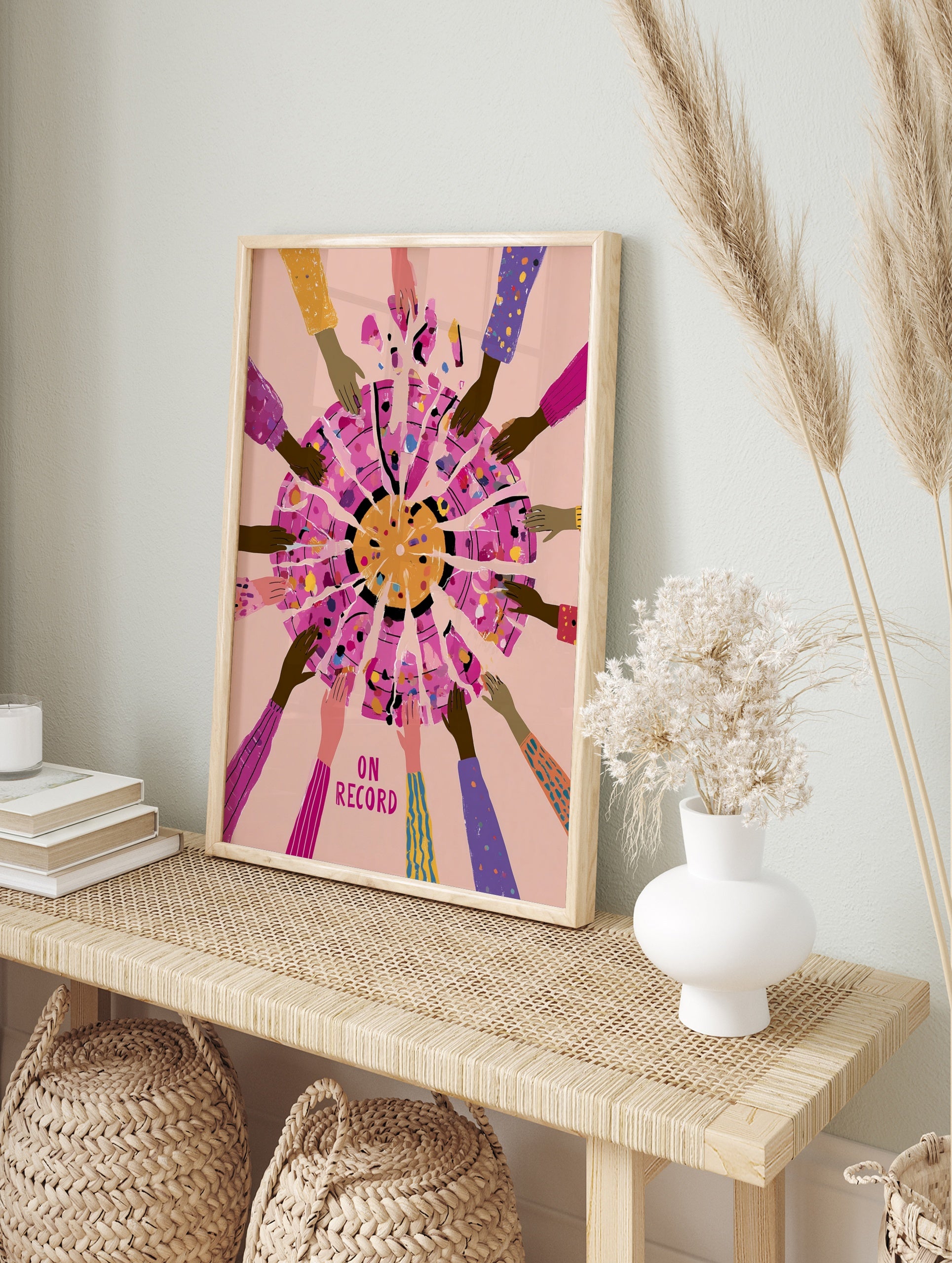 Illustrative art print of hands reaching towards a fragmented circle with text ON RECORD on a, in an alternate framed mockup