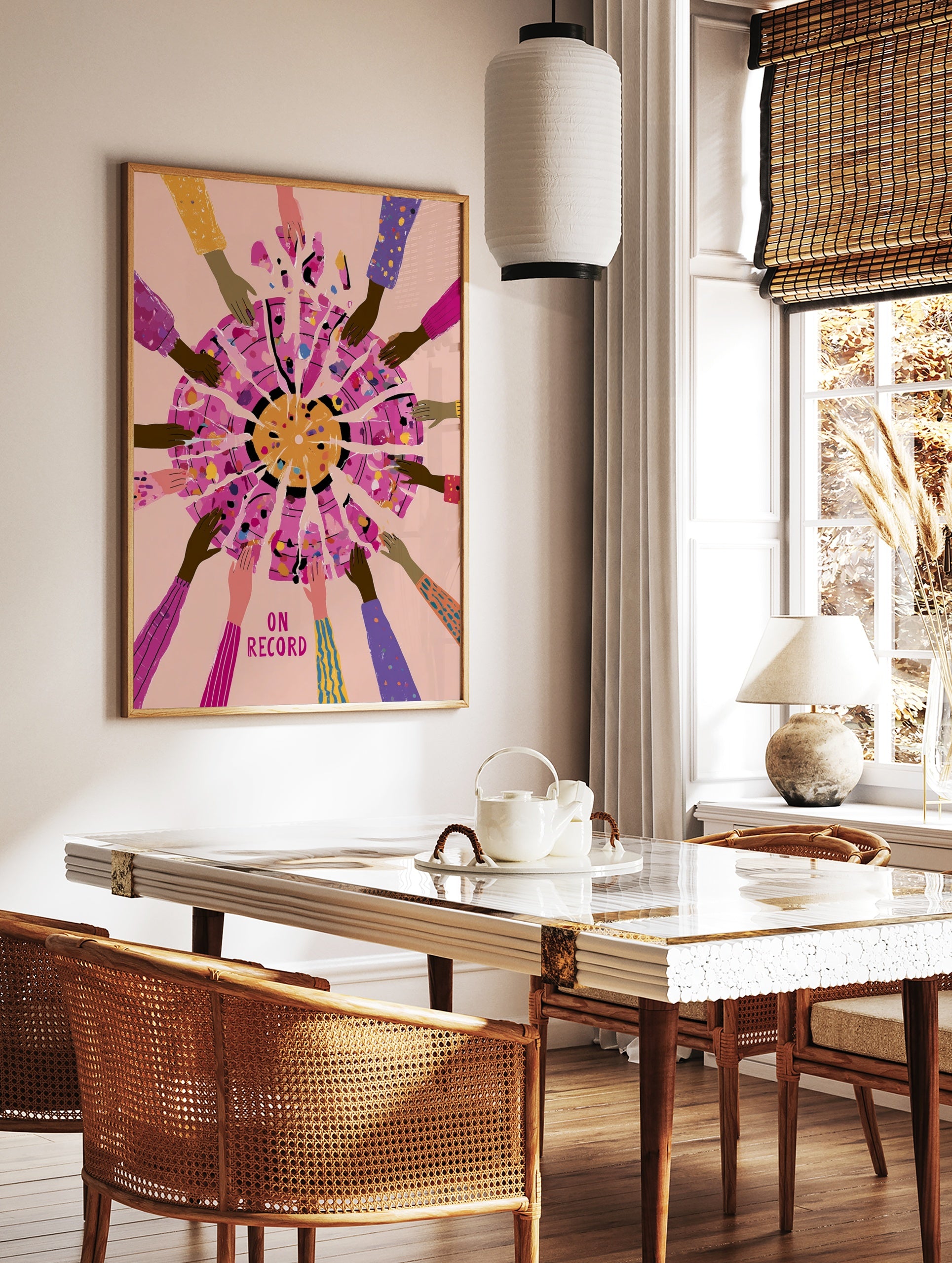 Illustrative art print of hands reaching towards a fragmented circle with text ON RECORD on a pink, in a styled room mockup