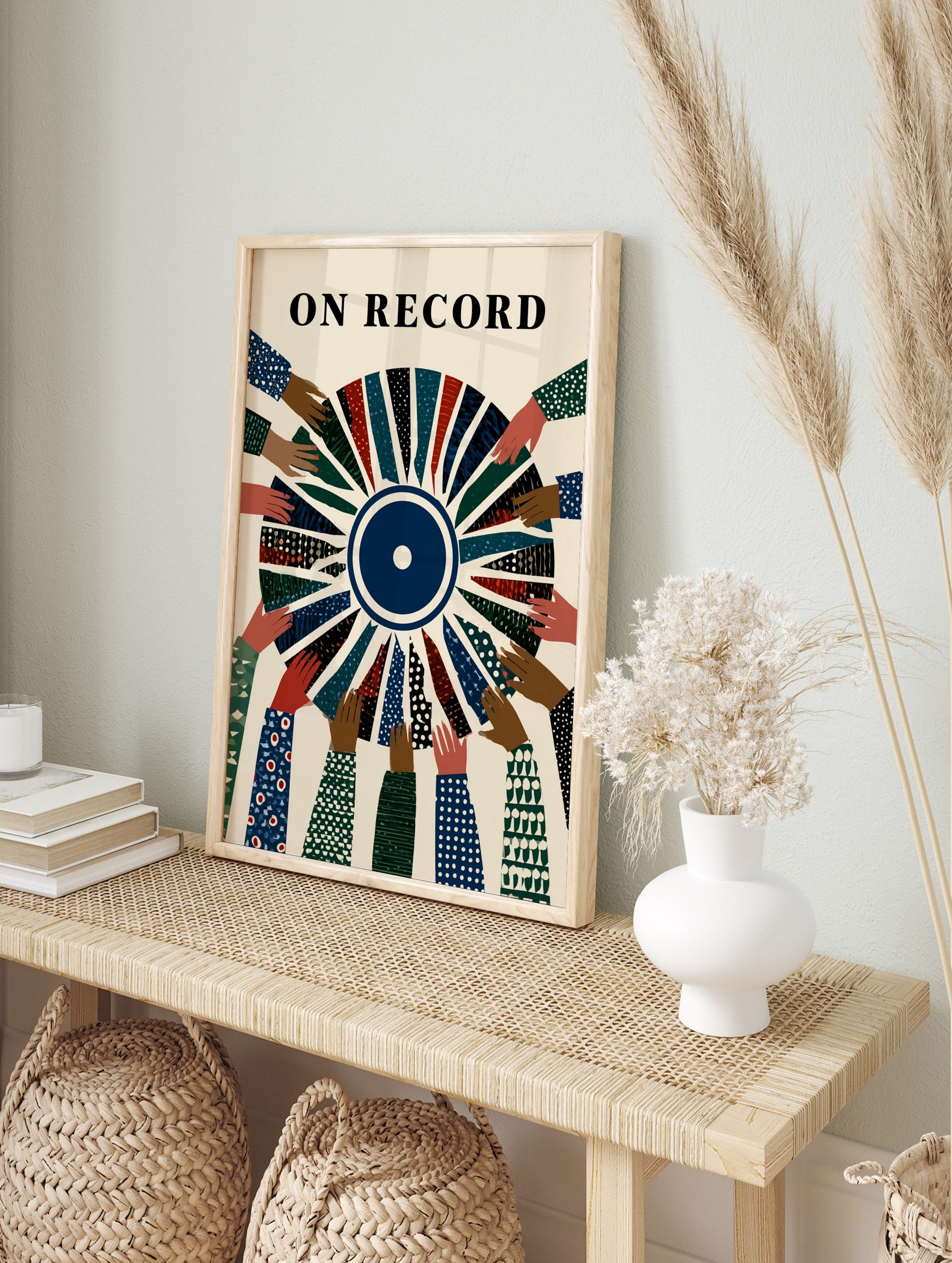 Illustrative On Record wall art featuring diverse hands holding a segmented vinyl record with, in an alternate framed mockup