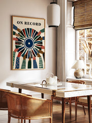 Illustrative On Record wall art featuring diverse hands holding a segmented vinyl record with, in a styled room mockup