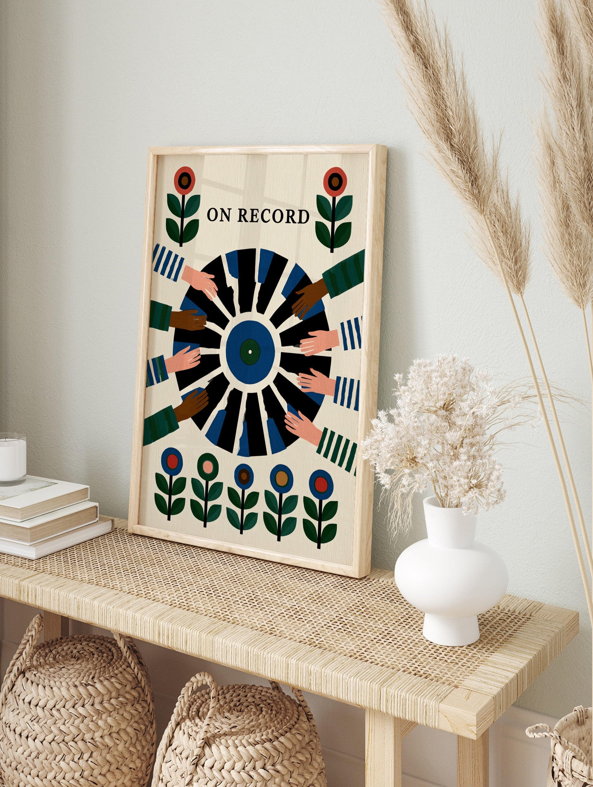 On Record wall art print showing a vinyl record held by multiple hands with floral motifs in, in an alternate framed mockup