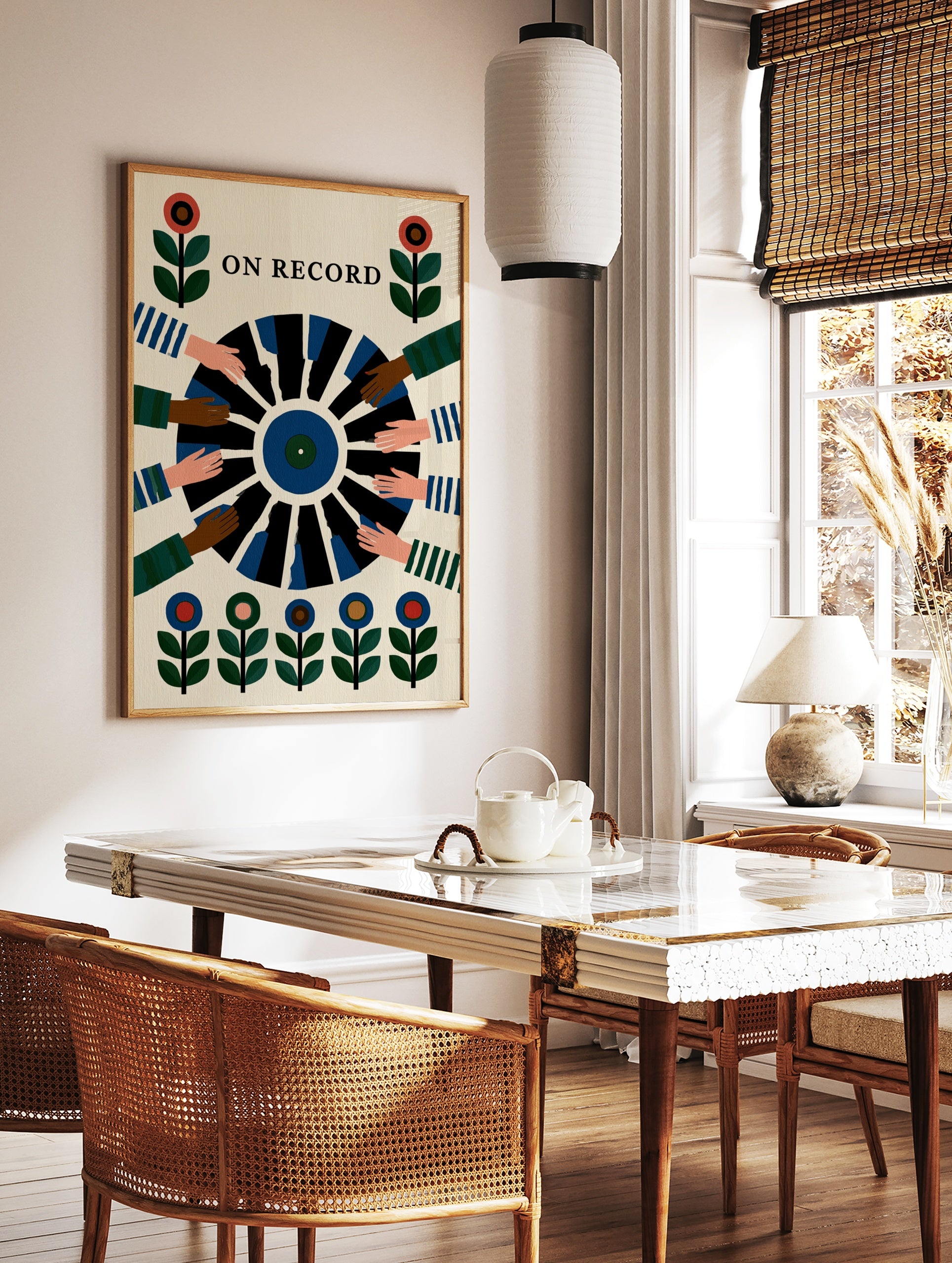 On Record wall art print showing a vinyl record held by multiple hands with floral motifs in a, in a styled room mockup