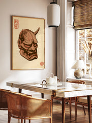 Japanese Oni mask illustration with horns, sharp teeth, and red kanji stamps on a tan background, in a styled room mockup