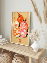 Illustrative print of a whole onion, garlic bulb, and onion slices in orange and pink tones, in an alternate framed mockup
