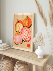 Stylised onion and garlic illustration on textured tan paper with a red artist stamp detail, in an alternate framed mockup