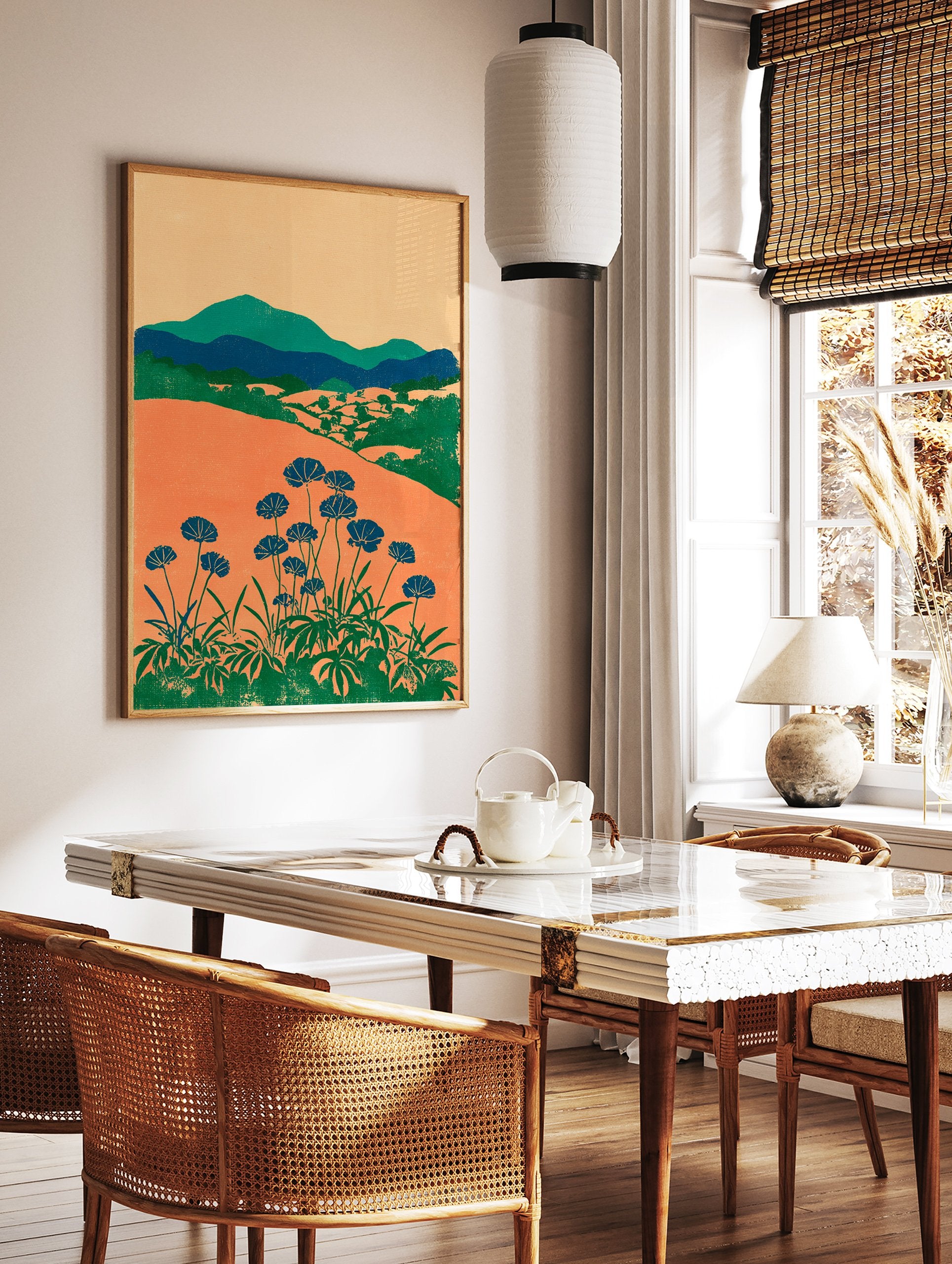 Modern botanical wall art print with orange fields, green mountains, and blue flowers on long stems against a light background. - Image 2
