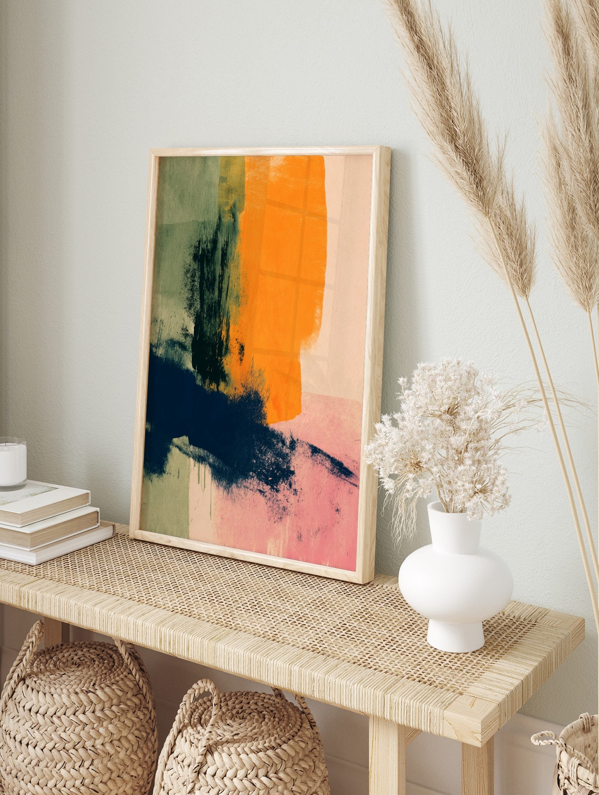 Abstract wall art with bold orange, navy blue, green, and pink brushstrokes on a textured, in an alternate framed mockup