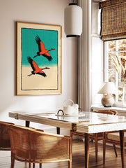 Two orange and black cranes flying against a teal sky and beige ground, in a Japanese illustrative wall art print. - Image 2