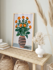 Illustrated orange flower bouquet in a pink and black striped vase on a neutral background, in an alternate framed mockup