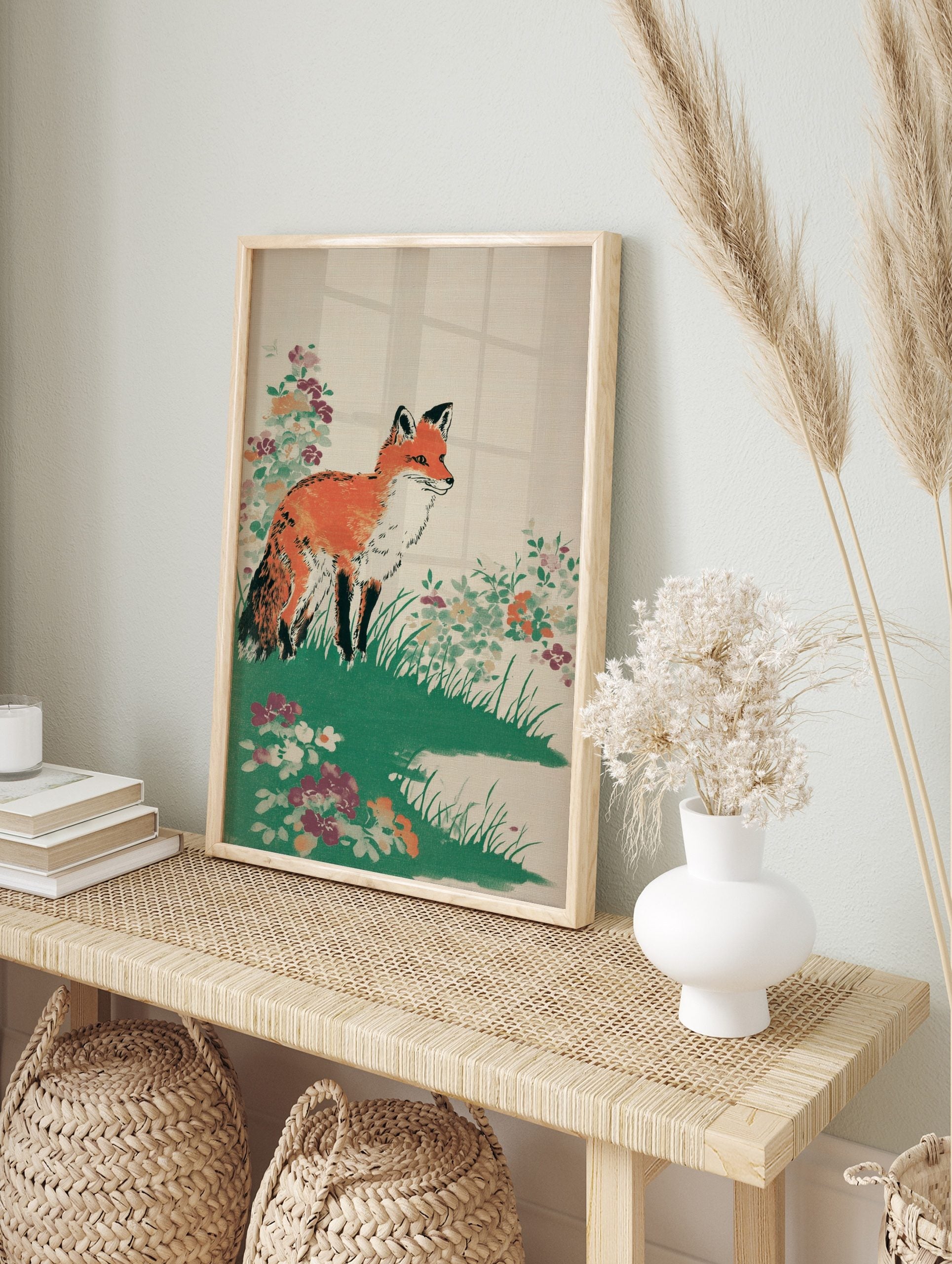 Illustrative print of an orange fox standing in green grass with colourful wildflowers on a, in an alternate framed mockup