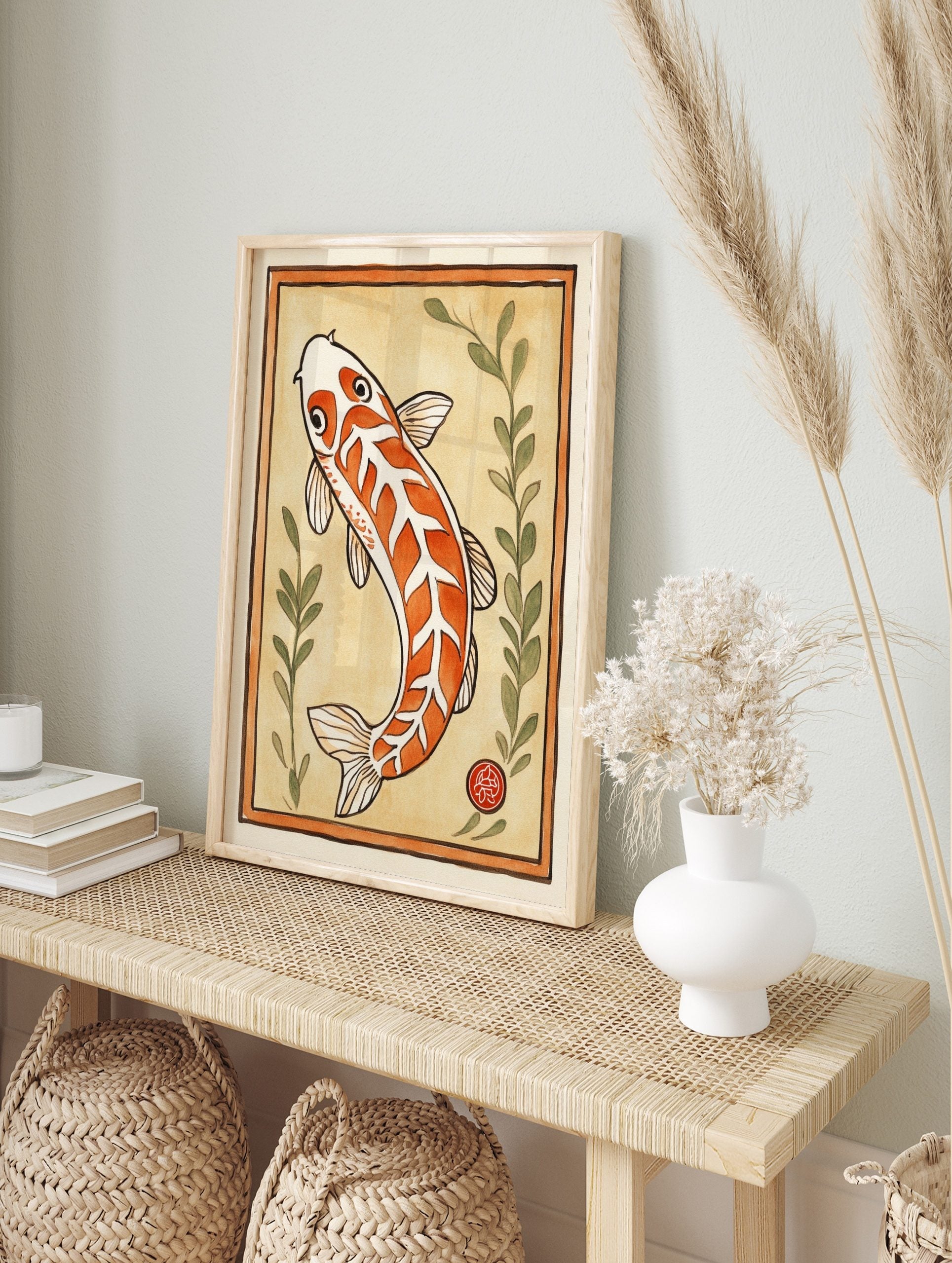 Orange and white koi fish illustration with green leaves and red seal mark, framed by a, in an alternate framed mockup
