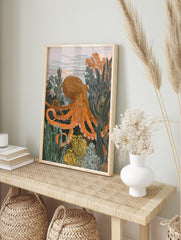 Illustrative orange octopus surrounded by green and yellow underwater plants, with a light, in an alternate framed mockup
