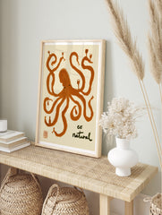 Stylized orange octopus illustration holding wine glasses and bottles with text 'eo natural', in an alternate framed mockup