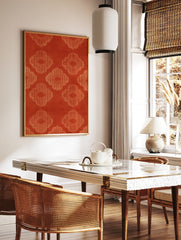 Orange quatrefoil pattern wall art with repeating geometric lattice motifs on a textured background, in a styled room mockup