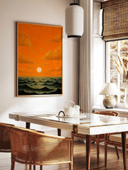 Dramatic orange sunset over dark wavy ocean with bright white sun and golden clouds, oil painting, in a styled room mockup