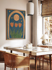 Illustrative print of three orange tulips, a smiling moon, and stars within a textured arch on a, in a styled room mockup