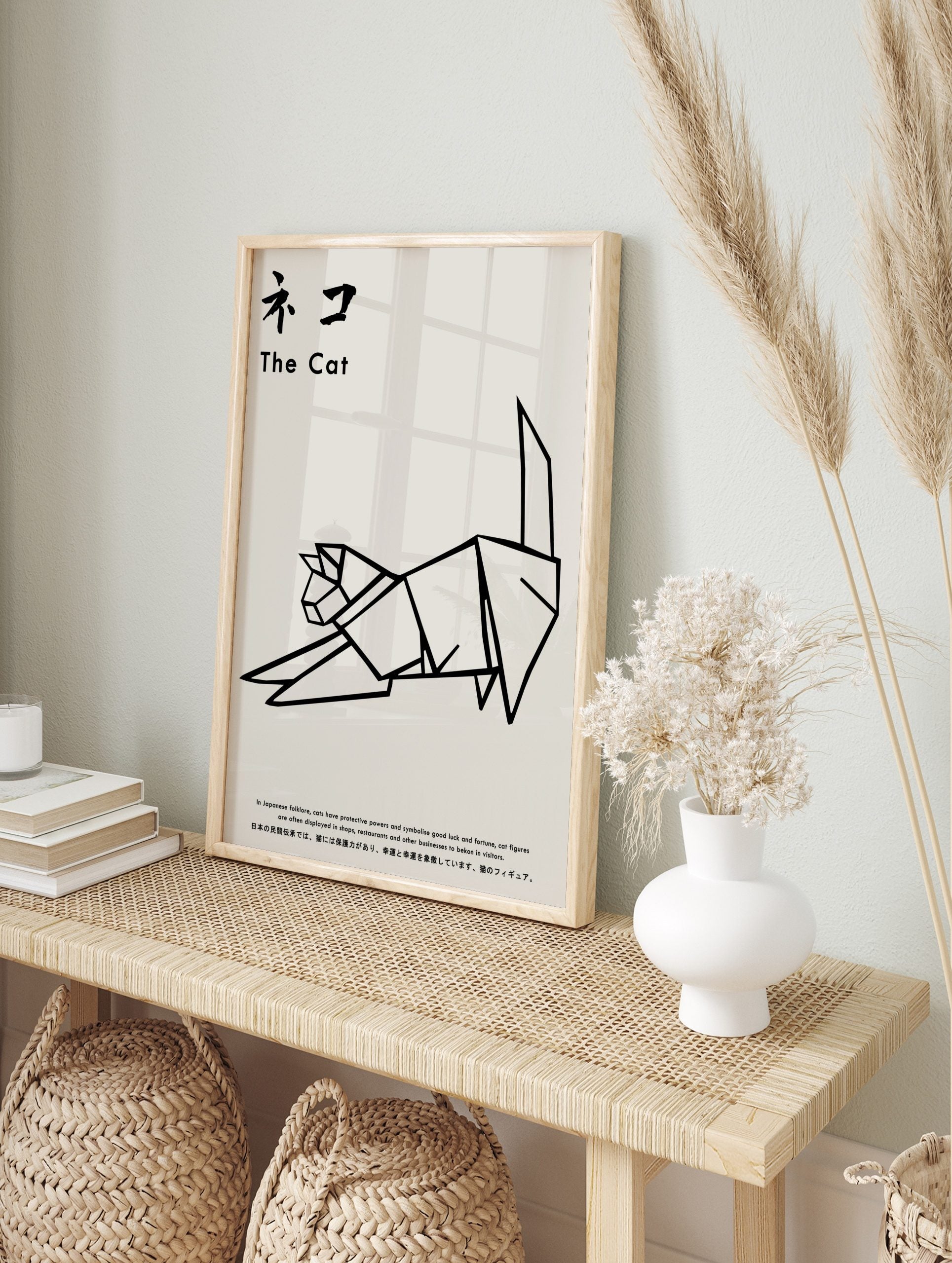 Minimalist black and white origami cat illustration art print with Japanese text, displayed as the same artwork in an alternate framed wall art mockup